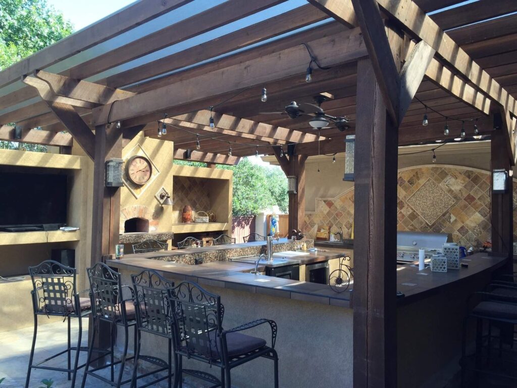Bespoke outdoor kitchen with fitted weatherproof cabinetry installed by Adam Kristian Image Title Luxury Outdoor Kitchen Installation