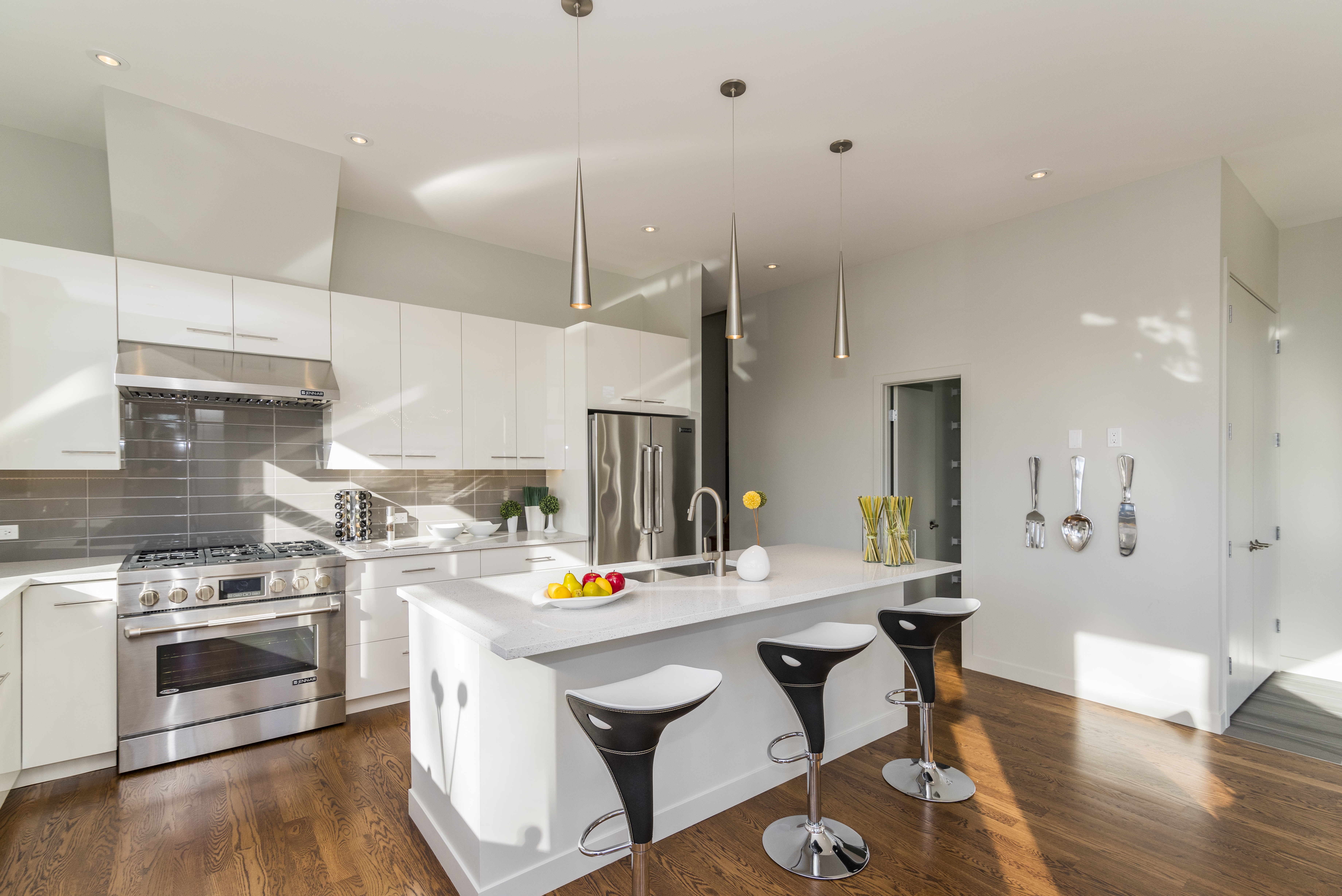Luxury contemporary white kitchen in Cheshire with island seating and open-plan modern design