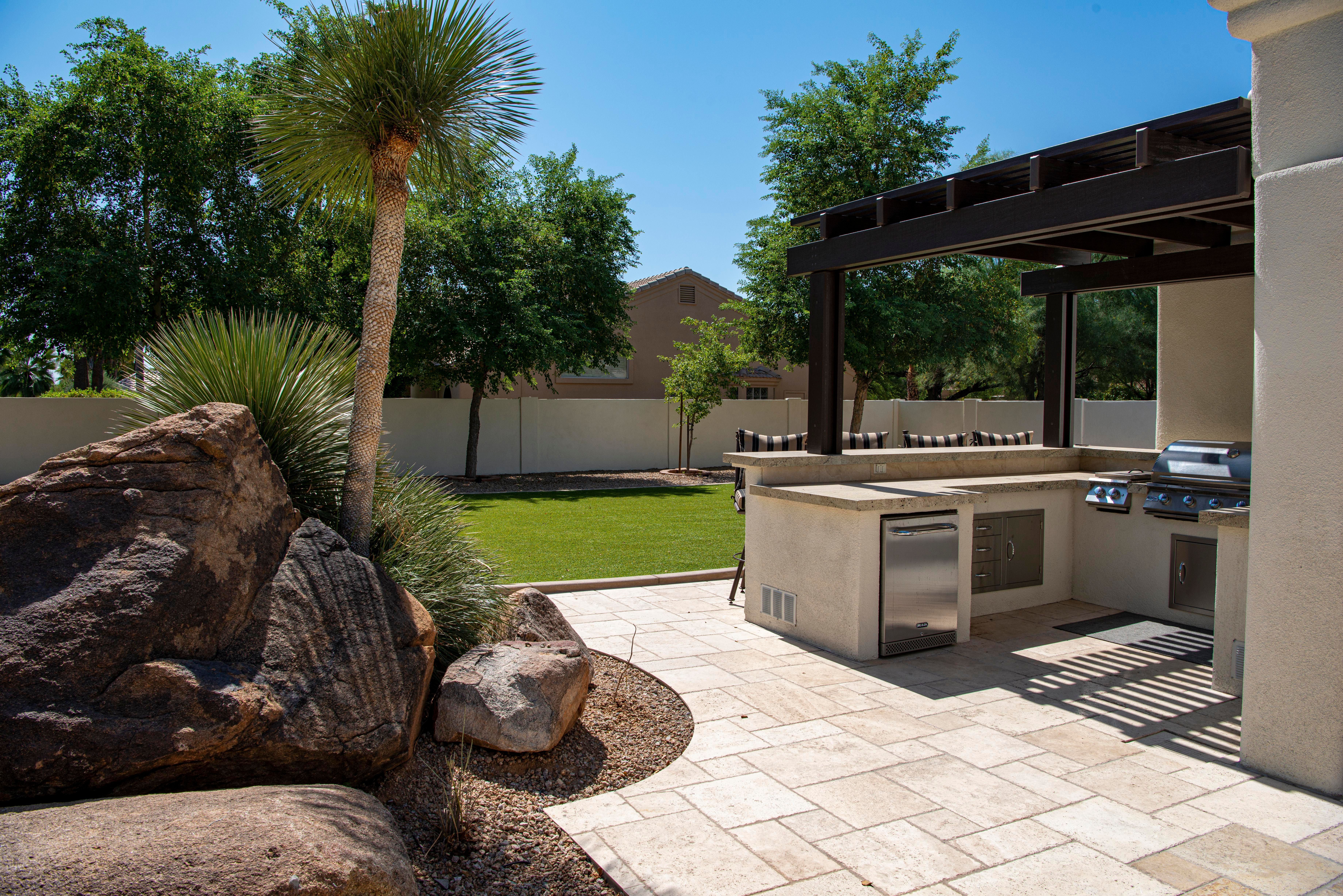 Contemporary outdoor living space with bespoke fitted furniture and garden seating during a UK summer heatwave