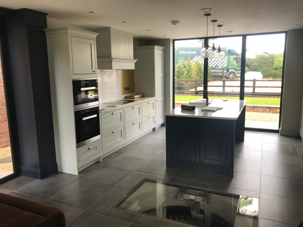 Adam Kristian bespoke in‑frame kitchen with island, handcrafted in UK factory